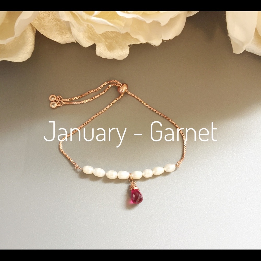 Rose Gold adjustable bracelet with garnet drop.